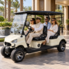 TXV 4+0 Four-Passenger Resort Cart Ivory TXV 4+0 electric golf cart carrying four guests at a Dubai resort